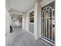 Long outdoor hallway features tiled flooring, white pillars, and a secure entrance to condos at 4310 Falmouth Dr # 105, Longboat Key, FL 34228