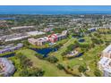 An aerial view shows the condo buildings in a scenic area with a community pool at 4550 Pinebrook Cir # 608, Bradenton, FL 34209