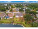 Aerial view of a neighborhood with houses, pond, and mature trees at 4621 34Th E Ct, Bradenton, FL 34203