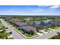 A picturesque aerial view of a residential area featuring homes surrounding a peaceful lake at 4718 Arbor Gate Dr, Bradenton, FL 34203