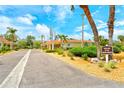 Inviting street view of charming villas with lush landscaping and ample parking at 4840 Gulf Of Mexico Dr # Villa 15, Longboat Key, FL 34228