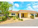 Exterior view of villa showcasing covered parking, red roof, and manicured landscaping at 4840 Gulf Of Mexico Dr # Villa 15, Longboat Key, FL 34228
