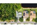 Aerial view of the home highlighting its proximity to lush greenery and a serene pond at 4920 Woodhurst Dr, Sarasota, FL 34243