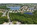 Aerial view showcasing the neighborhood's tranquil lakes, lush landscaping, and the home's location at 4920 Woodhurst Dr, Sarasota, FL 34243