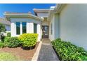 Charming entrance with lush landscaping and a stone walkway leading to the front door at 5035 Tobermory Way, Bradenton, FL 34211