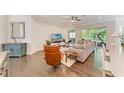 Bright living room with hardwood floors, neutral paint, and sliding glass doors to patio at 5035 Tobermory Way, Bradenton, FL 34211