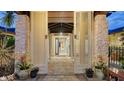 Elegant front entryway featuring stone columns, ornate doors, and decorative lion accents at 5500 Merrimac Dr, Sarasota, FL 34231