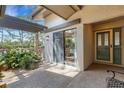 Cozy patio space with a sliding glass door entrance, stone accents, and space for seating at 5626 Pipers Waite # 22, Sarasota, FL 34235
