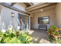 Inviting patio space with seating area and view through sliding glass door entrance with ample light at 5626 Pipers Waite # 22, Sarasota, FL 34235