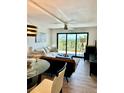 Bright living room with modern decor, large windows, and scenic views overlooking lush greenery at 5855 Midnight Pass Rd # 621, Sarasota, FL 34242