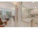 Open-concept kitchen with granite countertops, stainless appliances, and an inviting view into the living area at 5916 Midnight Pass Rd # 404, Sarasota, FL 34242
