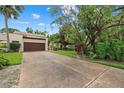 Exterior of a home featuring a two-car garage, concrete driveway and lush front yard at 6207 Courtside Dr # 23, Bradenton, FL 34210