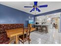 Eat-in kitchen with white cabinets, an island with bar seating, and a table with a built-in bench at 6207 Courtside Dr # 23, Bradenton, FL 34210