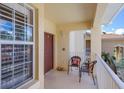 Inviting outdoor balcony area with seating for two, providing a relaxing spot to enjoy the view at 7179 Boca Grove Pl # 202, Lakewood Ranch, FL 34202
