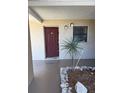 View of the front entryway featuring a plant and the front door at 7273 Cloister Dr # 121, Sarasota, FL 34231