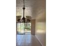 Bright living room with tile floors and sliding glass doors to the patio at 7273 Cloister Dr # 121, Sarasota, FL 34231