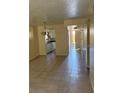Living room with tile floors leading to kitchen and front door at 7273 Cloister Dr # 121, Sarasota, FL 34231