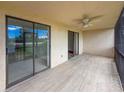 This screened lanai offers outdoor living space with a ceiling fan and sliding glass doors to the inside at 7500 40Th W Ave # 108, Bradenton, FL 34209