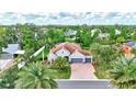 An aerial view of a gray home with lush green landscaping and mature trees surrounding the property at 7705 55Th E St, Ellenton, FL 34222