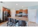 Spacious kitchen with a granite island, seating, and stainless steel appliances at 10944 Rainbow Pyrite Dr, Wimauma, FL 33598