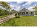 Well-maintained home with a manicured lawn, and a covered car portico. Large windows bring in natural light at 1108 64Th Street E Ct, Bradenton, FL 34208
