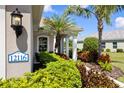 Close-up showcasing the home's address and beautifully landscaped garden with mature plantings at 12116 Stuart Dr, Venice, FL 34293