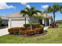 Charming single-story home featuring an attached two-car garage and meticulously landscaped front yard at 12116 Stuart Dr, Venice, FL 34293