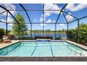 Sparkling pool and screened in lanai with lake views providing a serene outdoor living space at 12116 Stuart Dr, Venice, FL 34293