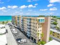 Low angle view of the condo exterior showing balconies, parking, and exterior design at 1255 Tarpon Center Dr # 309, Venice, FL 34285