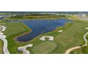 Aerial view of a beautiful golf course and serene lake at 12680 Radiance Ct # 12-101, Venice, FL 34293
