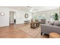 Bright living room featuring wood-look floors, neutral-toned furniture, and a large clock at 1345 24Th St, Sarasota, FL 34234