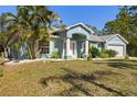 Charming single-story home featuring a well-kept lawn, two-car garage and attractive curb appeal at 1399 Shields St, Punta Gorda, FL 33980