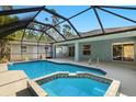 Enjoy the pool and integrated spa with screened enclosure, and access to the house at 1399 Shields St, Punta Gorda, FL 33980
