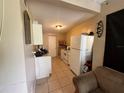 Cozy kitchen features white appliances and tile flooring at 1909 6Th W Ave, Palmetto, FL 34221
