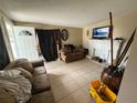 Comfortable living room with tiled floors, fireplace, and neutral décor at 1909 6Th W Ave, Palmetto, FL 34221