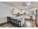 Bright kitchen featuring a marble countertop island, stainless steel appliances, and sleek white cabinets at 217 22Nd Street Ne Ct, Bradenton, FL 34208