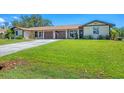 Well-maintained exterior with green lawn, double garage, and inviting curb appeal at 217 High Point Dr # 217A, Englewood, FL 34223