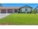 Well-maintained front yard with a lush green lawn and an attached garage for convenient parking at 217 High Point Dr # 217A, Englewood, FL 34223