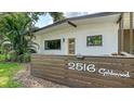 Inviting exterior view featuring a contemporary design with a bright door and verdant landscaping at 2516 Goldenrod St, Sarasota, FL 34239