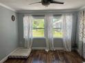 Inviting bedroom featuring hardwood floors, neutral paint, and bright windows at 2722 9Th Ave W, Bradenton, FL 34205