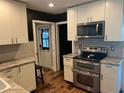 Modern kitchen with white cabinets, stainless steel appliances, and granite countertops at 2722 9Th Ave W, Bradenton, FL 34205