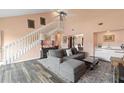 Inviting living room boasting high ceilings, wood flooring, and large windows for natural light at 3910 77Th E Pl, Sarasota, FL 34243
