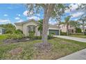 Beautifully landscaped front yard showcasing lush greenery, a well-maintained lawn, and mature trees at 4103 61St E Ave, Bradenton, FL 34203