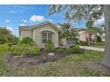 Charming home with a neatly landscaped front yard, featuring mature trees and shrubs for added curb appeal at 4103 61St E Ave, Bradenton, FL 34203