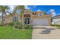 Charming single Gathering home boasts a lush landscaped yard and attached two car garage at 4274 Tennyson Way, Venice, FL 34293