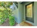 Charming front door framed by lush landscaping and exterior accents at 4500 Chinkapin Dr, Sarasota, FL 34232