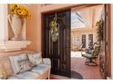 Welcoming entryway leading to a screened patio, with comfortable bench and decorative floral arrangement at 4804 Jacaranda Heights Dr, Venice, FL 34293