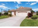 Beautifully landscaped home featuring a pristine driveway and lush green lawn at 4804 Jacaranda Heights Dr, Venice, FL 34293