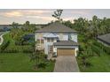 An aerial view shows a luxurious home with a backyard pool surrounded by lush greenery at 5651 Trevesta Pl, Palmetto, FL 34221
