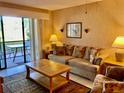 Comfortable living room featuring sliding glass doors to a patio, plush seating, and neutral decor for a relaxing atmosphere at 6124 43Rd W St # 104A, Bradenton, FL 34210